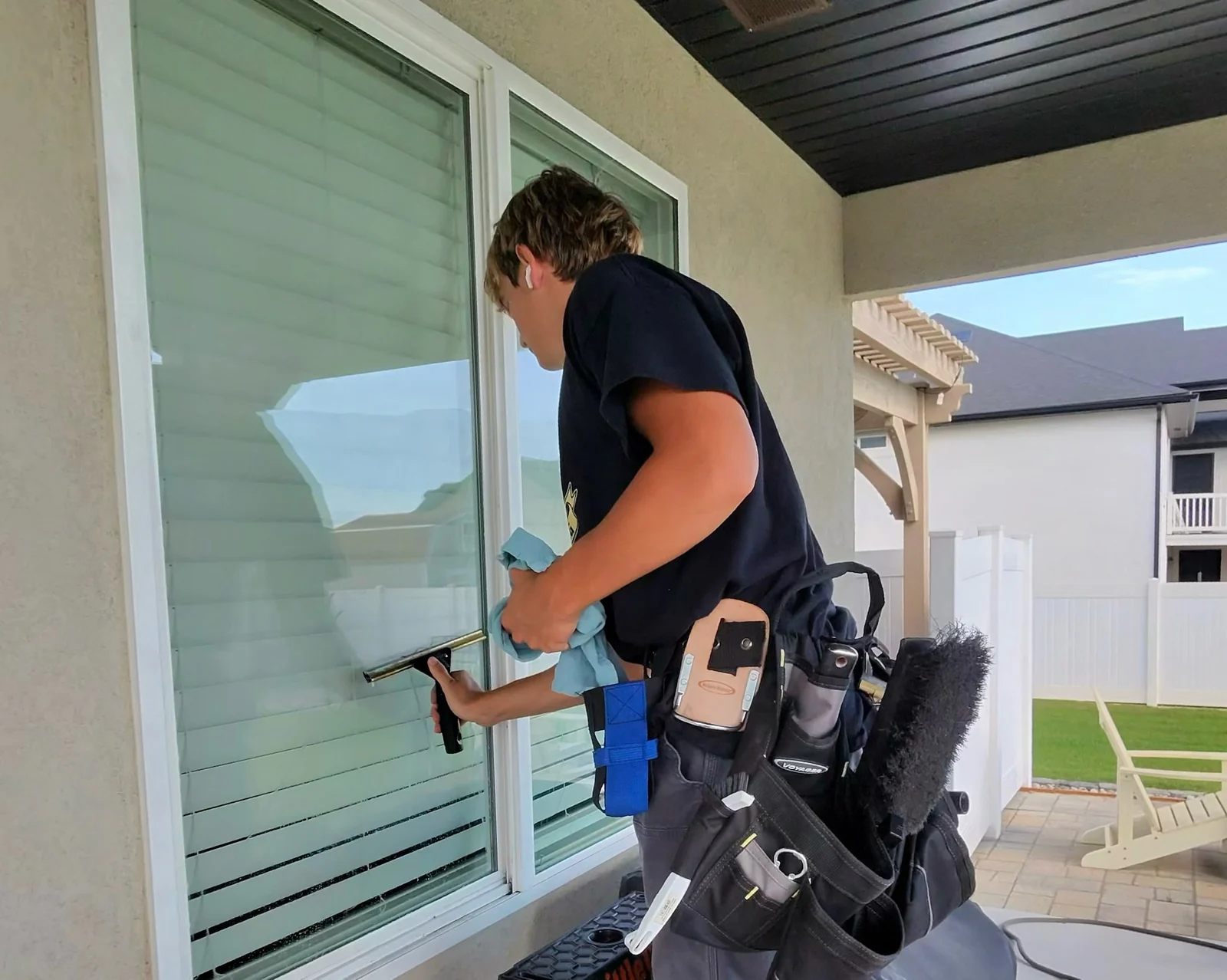 Clearly Clean technician cleaning a home's windows